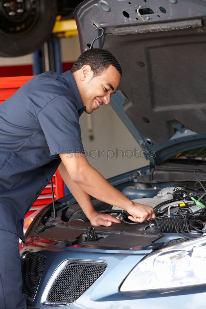 Similar – Professional Mechanic Repairing Car.