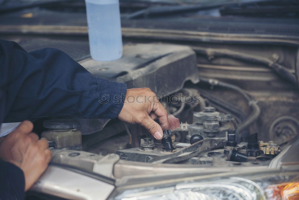 Similar – Professional Mechanic Repairing Car.