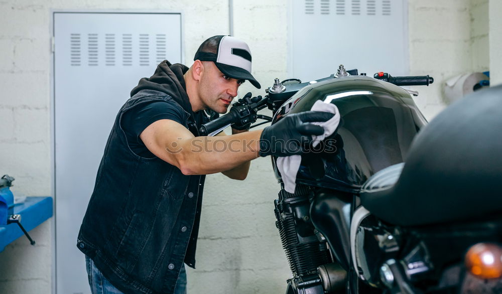 Similar – Image, Stock Photo Mechanic cleaning a motorcycle
