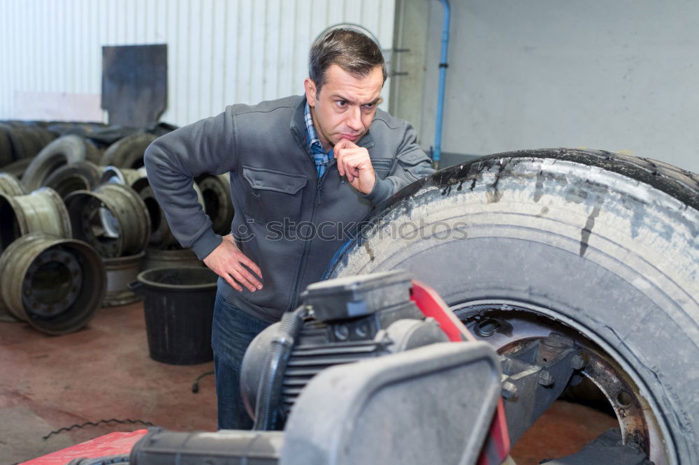 Similar – Image, Stock Photo Mechanic checking wheel of a customized motorcycle