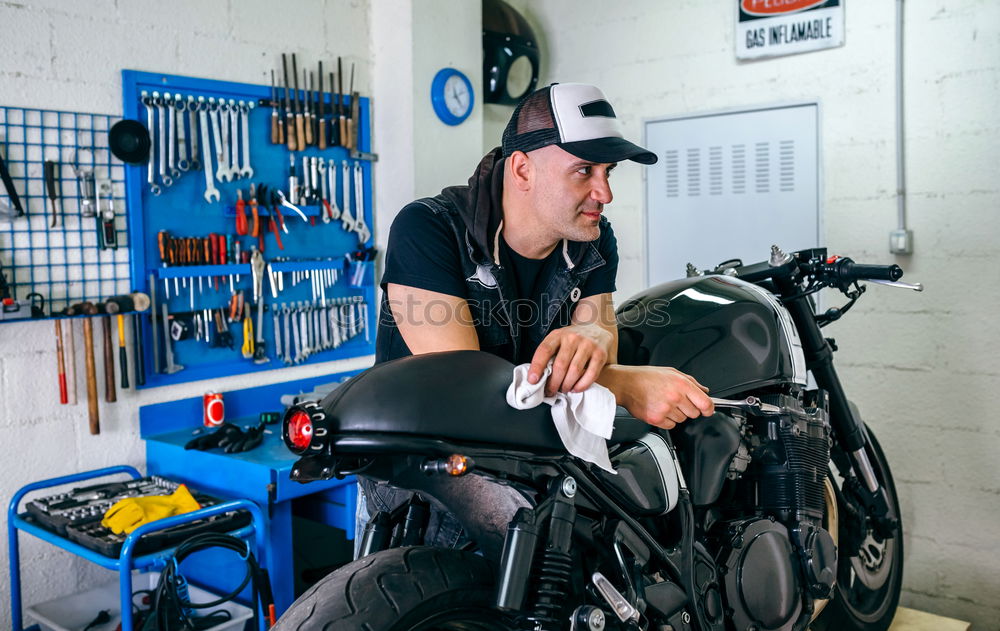 Image, Stock Photo Mechanic cleaning a motorcycle