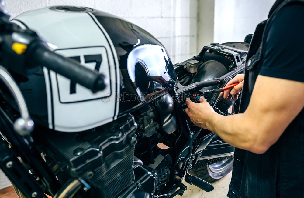 Image, Stock Photo Mechanic repairing customized motorcycle