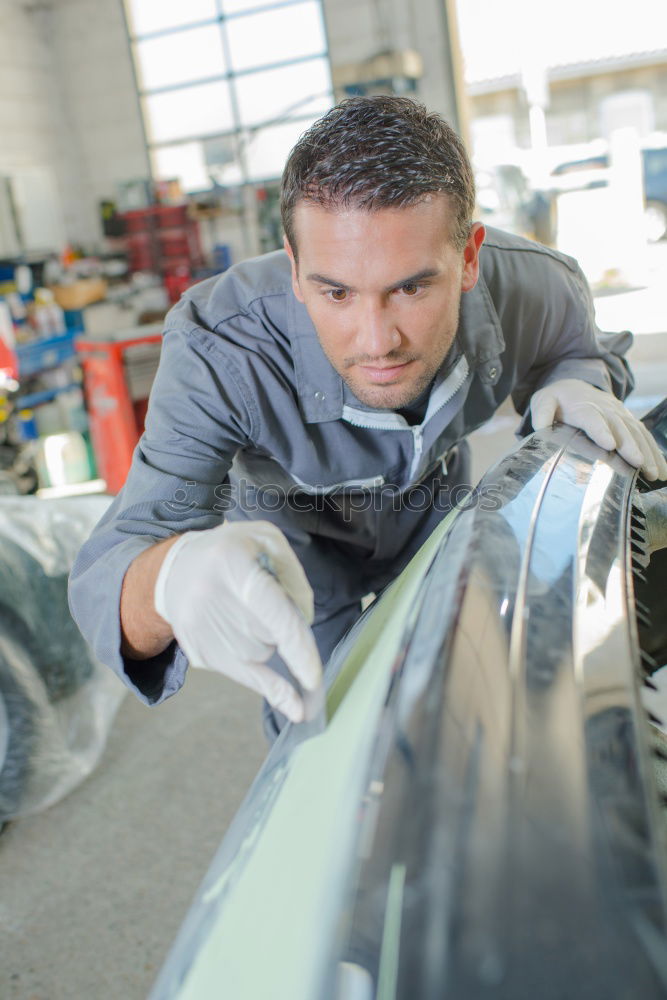 Professional Mechanic Repairing Car.