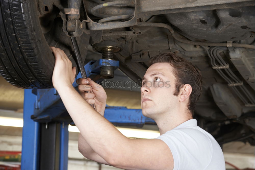 Similar – Professional Mechanic Repairing Car.