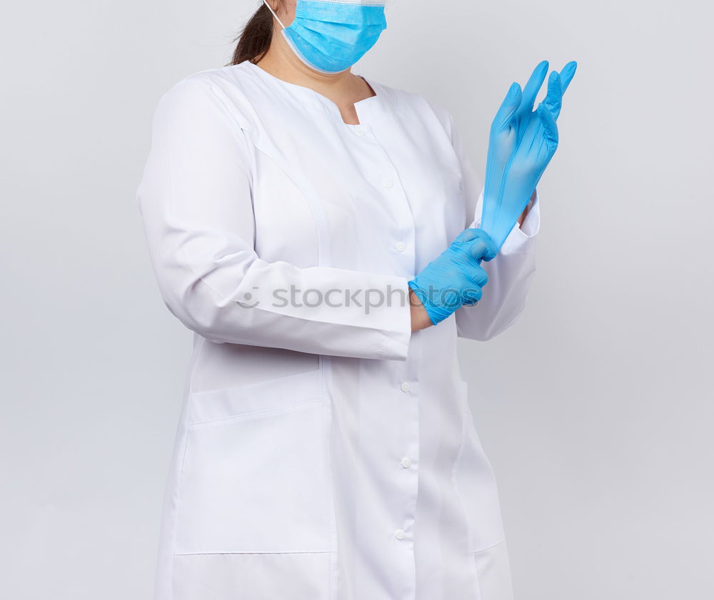 Similar – portrait of doctor woman wearing protective mask and gloves indoors. Using mobile phone. Corona virus concept