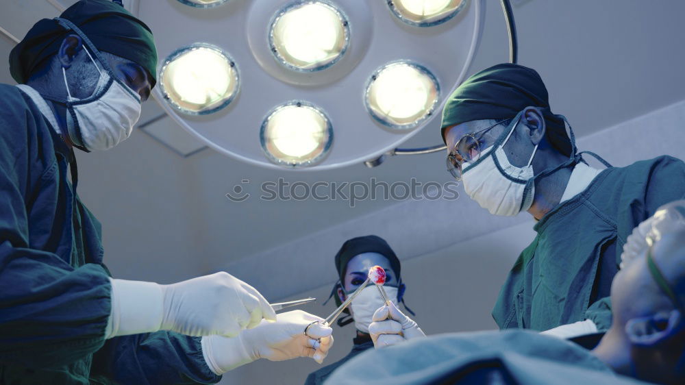 Similar – Image, Stock Photo Team of Surgeons Operating.