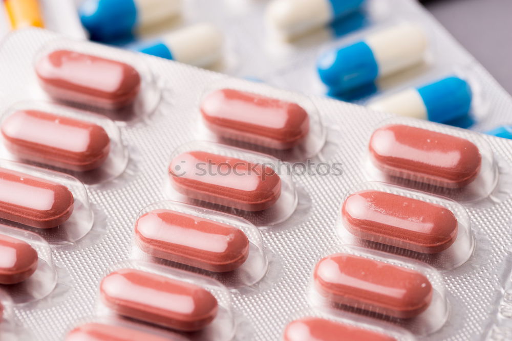 Similar – Pink round tablets pills in blister pack on pink background. Painkiller medicine. Take pill. Pharmacy product package. Pharmaceutical industry. Prescription drugs. Tablets pills for relieve pain.