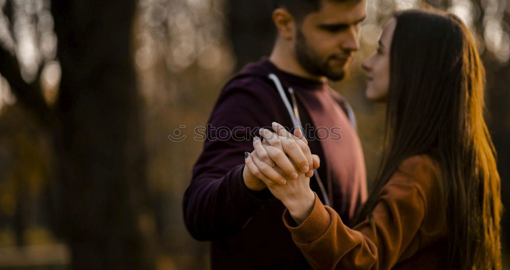 Similar – Portrait of beautiful couple in casual wear hugging in the street