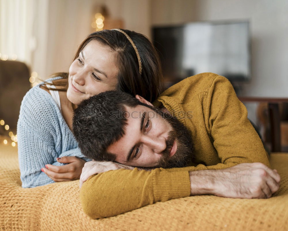 Similar – Couple laying on couch watching TV together