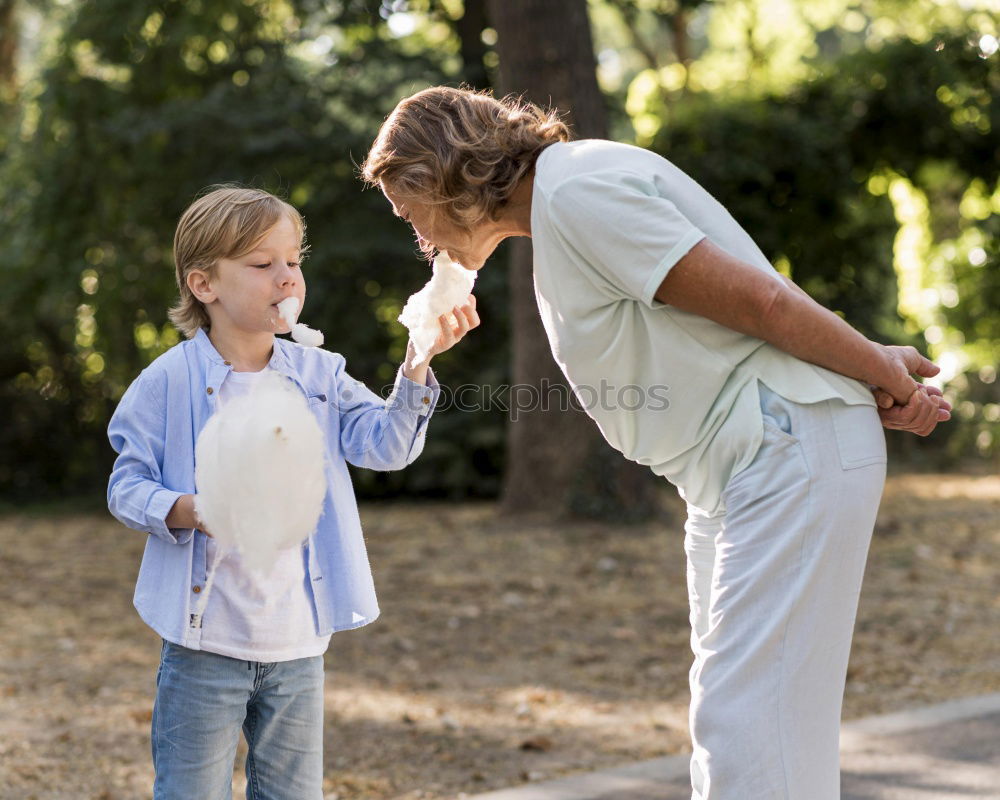 Similar – Image, Stock Photo Smiling little child with smart phone taking picture of happy grandmother and grandfather. Family leisure outdoor