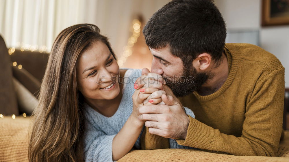 Similar – Couple laying on couch watching TV together