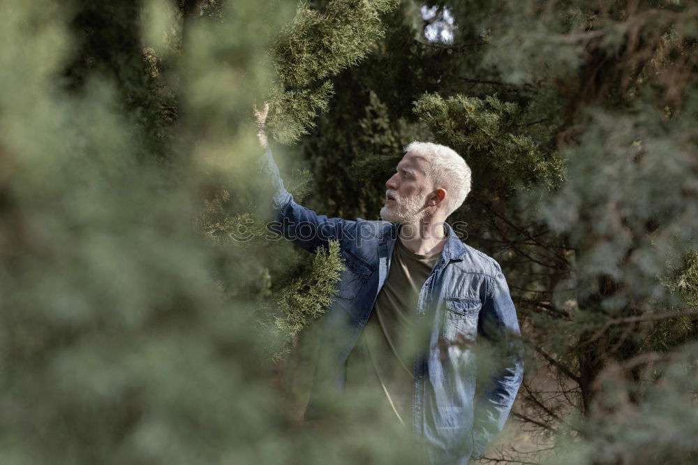 Similar – Senior citizen looks up in the forest