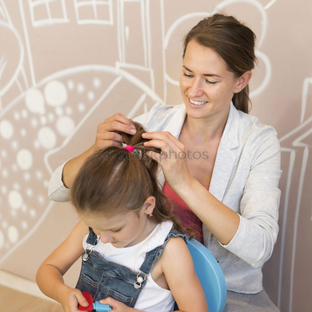 Similar – mother brushing toddler daughter’s hair