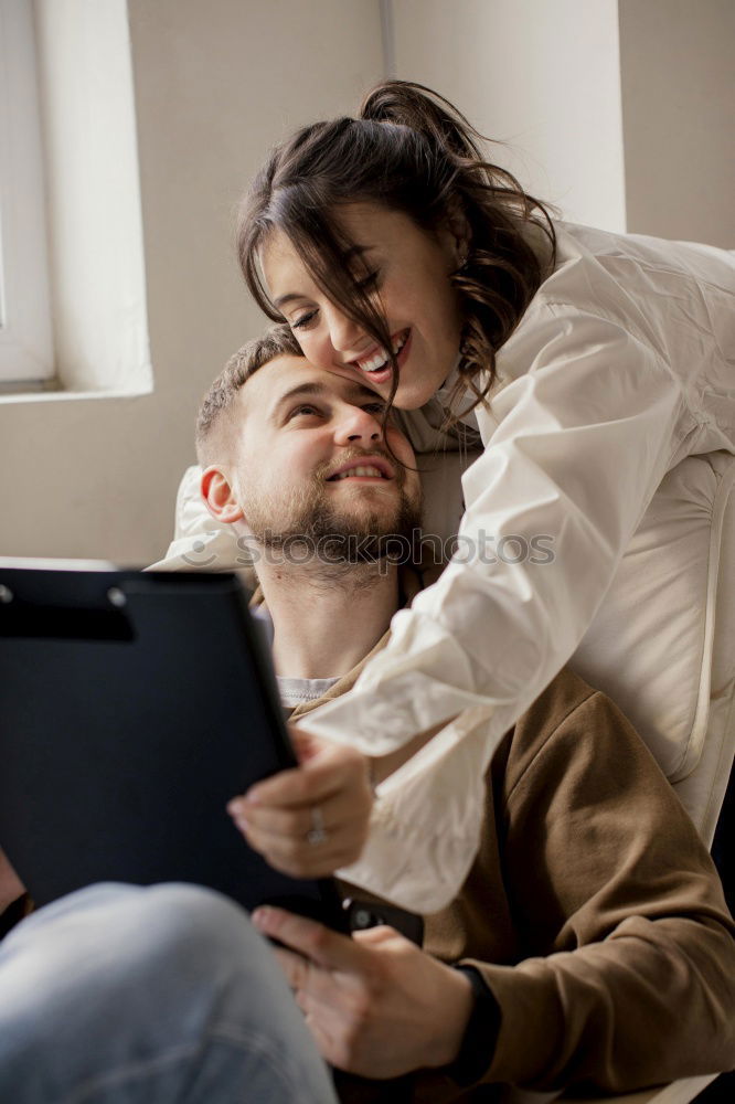 Similar – Image, Stock Photo Young couple reading book on couch at home