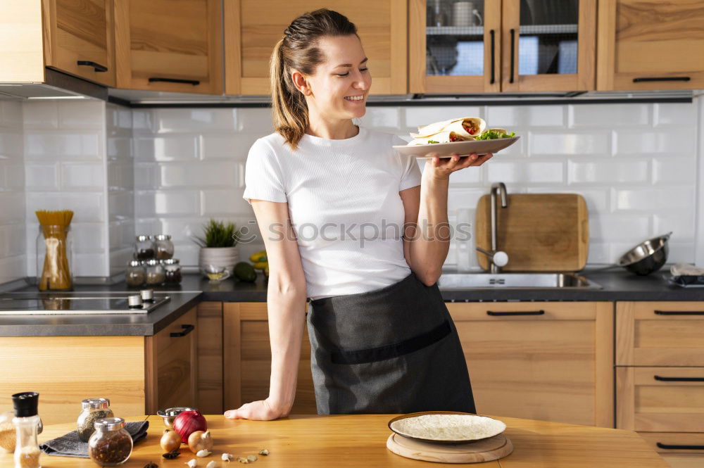 Similar – Image, Stock Photo Young couple cooking. Man and woman in their kitchen