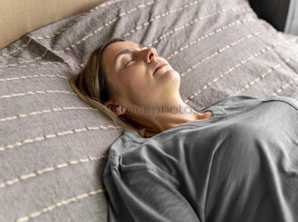 Portrait of a beautiful adult woman lying on a bed