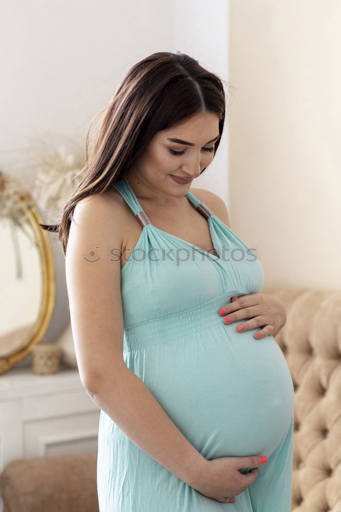 Similar – Pregnant woman touching her belly