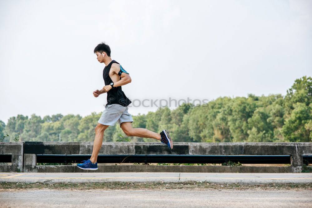 Black man running outdoors in urban road