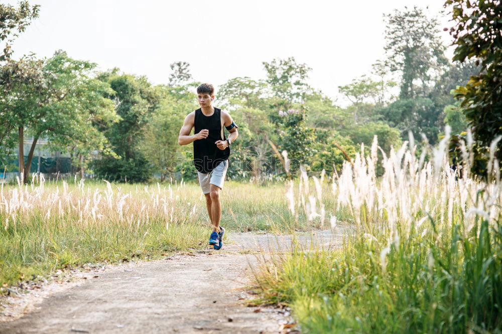 Similar – Image, Stock Photo Fit muscular man jogging on a rural trail