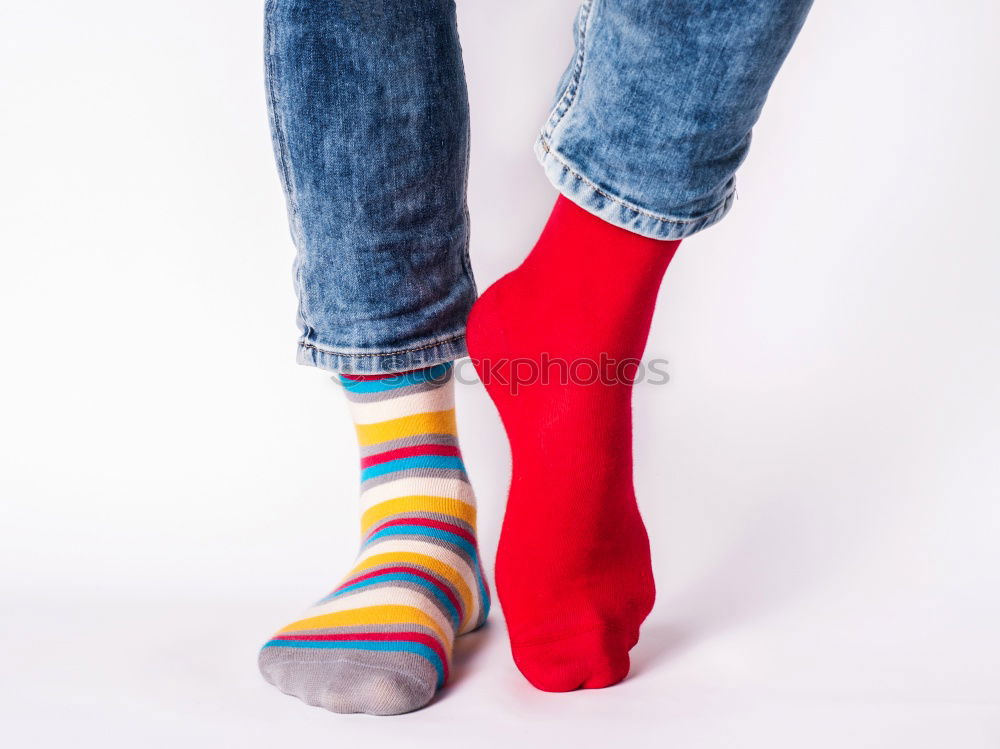 Similar – Gemusterte Socken in roten Badelatschen