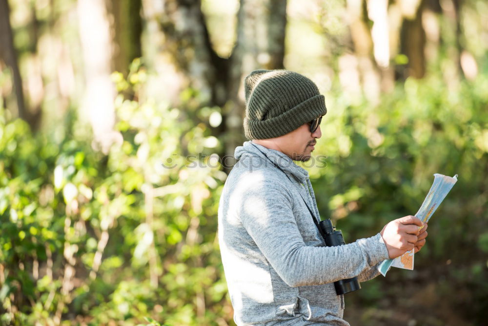 Similar – Man navigating on road in woods