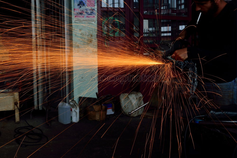 Similar – Unrecognizable worker cutting metal in garage