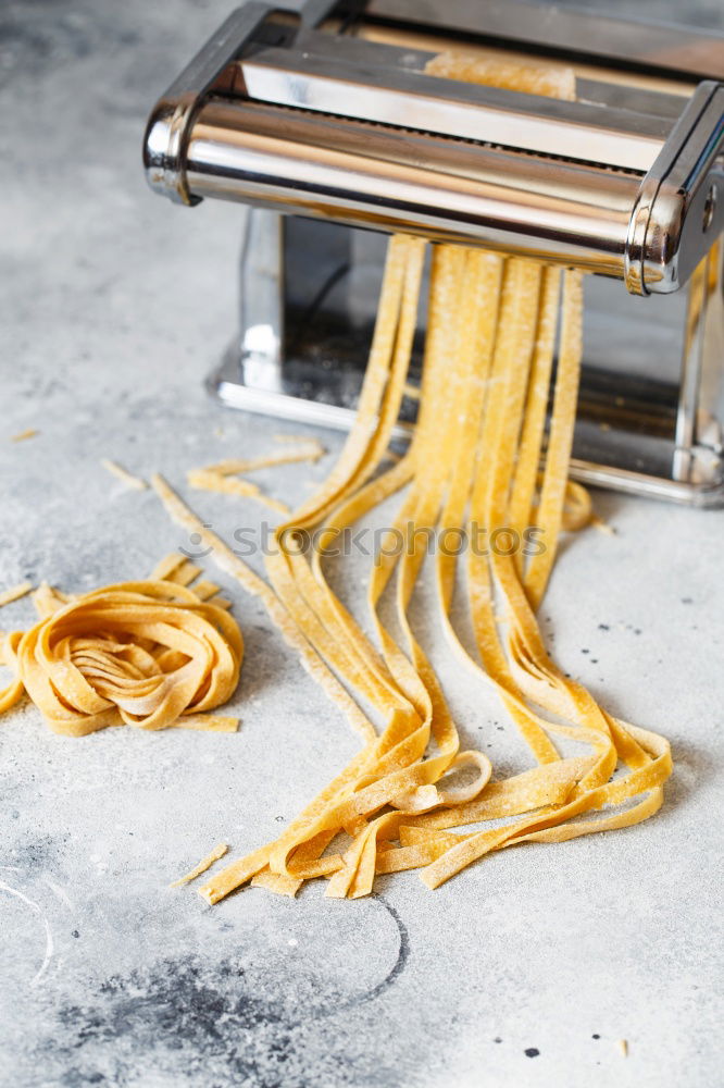 Similar – Image, Stock Photo Making homemade taglatelle with a pasta rolling cutter