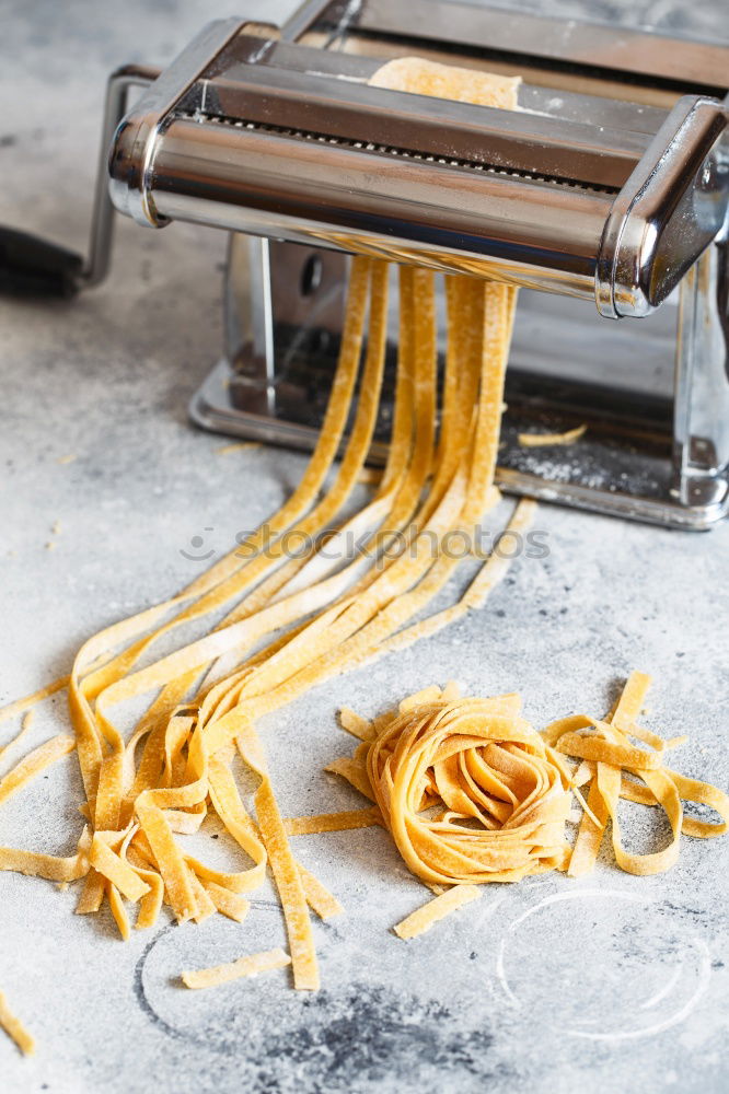 Similar – Image, Stock Photo Making homemade taglatelle with a pasta rolling cutter