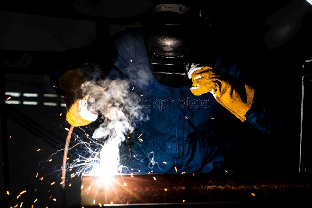 Similar – worker using an angle grinder