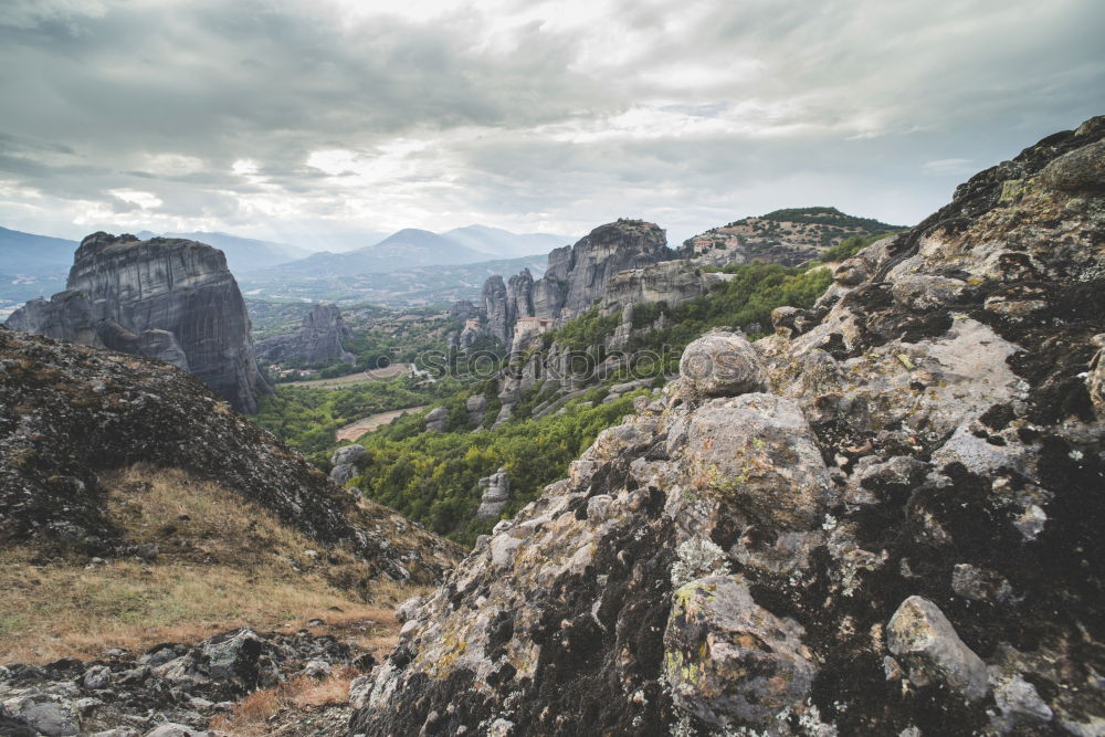 Similar – A vast expanse of fields and mountains full of trees taken from the top of a cliff