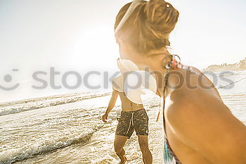 Man with skateboard looking at sea