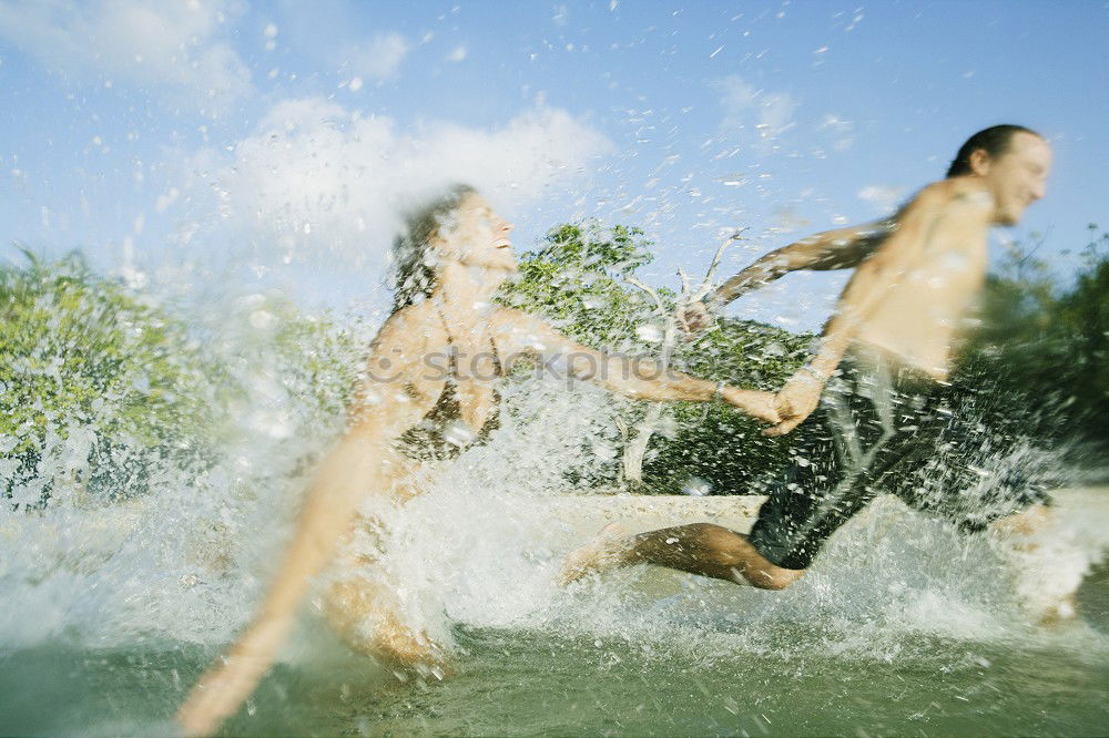 Similar – Two young men jump into the water