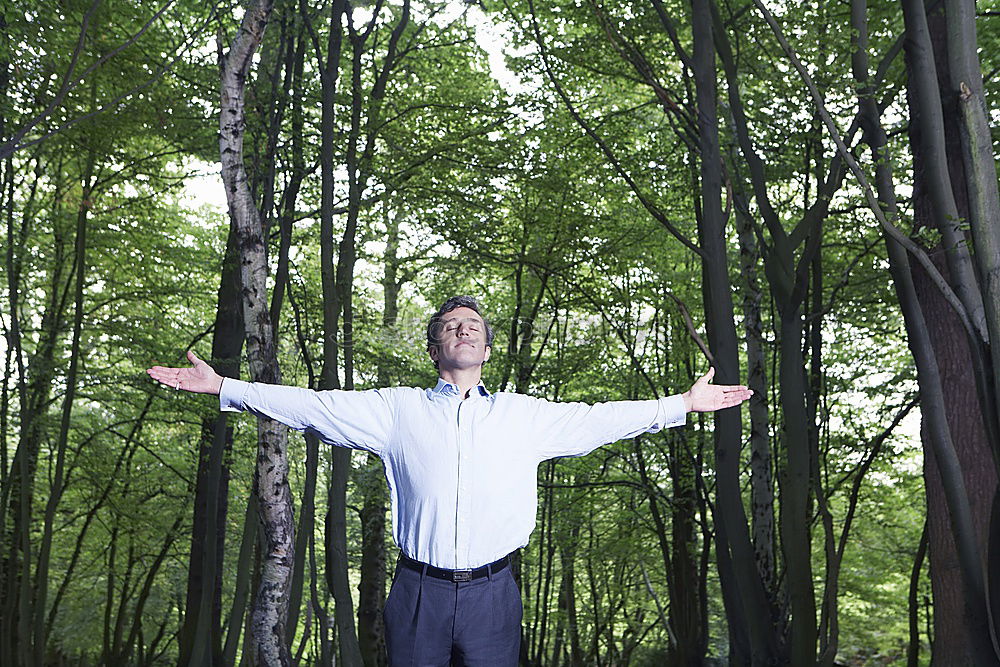 Similar – Senior citizen looks up in the forest