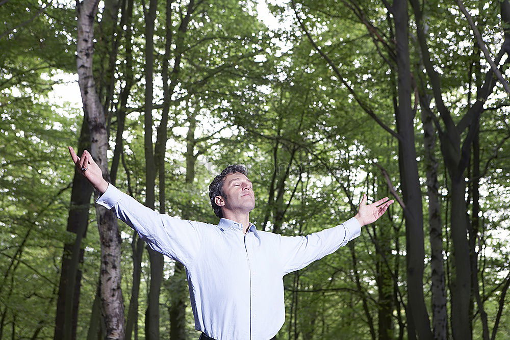 Similar – Senior citizen looks up in the forest