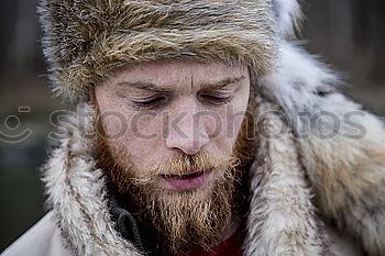 Similar – Happy man with a mustache in a knitted winter cap and warm winter clothing