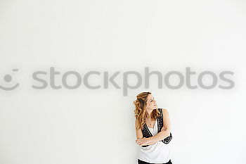 Similar – Young woman leaning on white wall