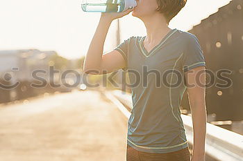 Similar – Fit sporty woman drinking water from a bottle