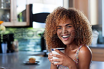 Woman in a countryside house garden drinking wine