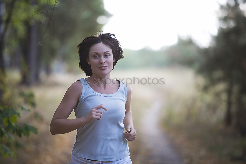 Similar – Cheerful woman running through field