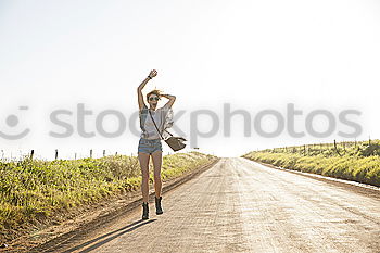 Similar – Image, Stock Photo Young adult group of friends riding longboards on road together