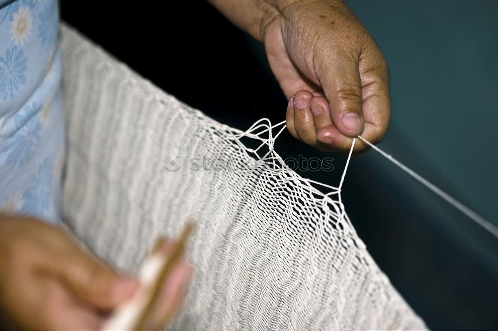 Similar – Close up of the hands of an elderly woman knitting sock