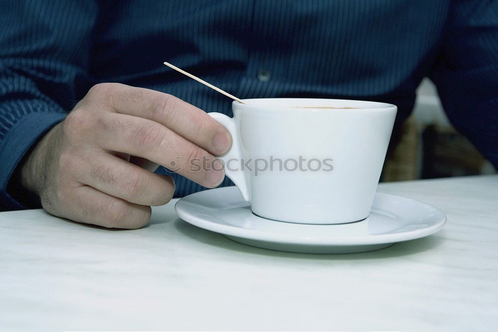 Hands with coffee cups on table in a urban cafe.