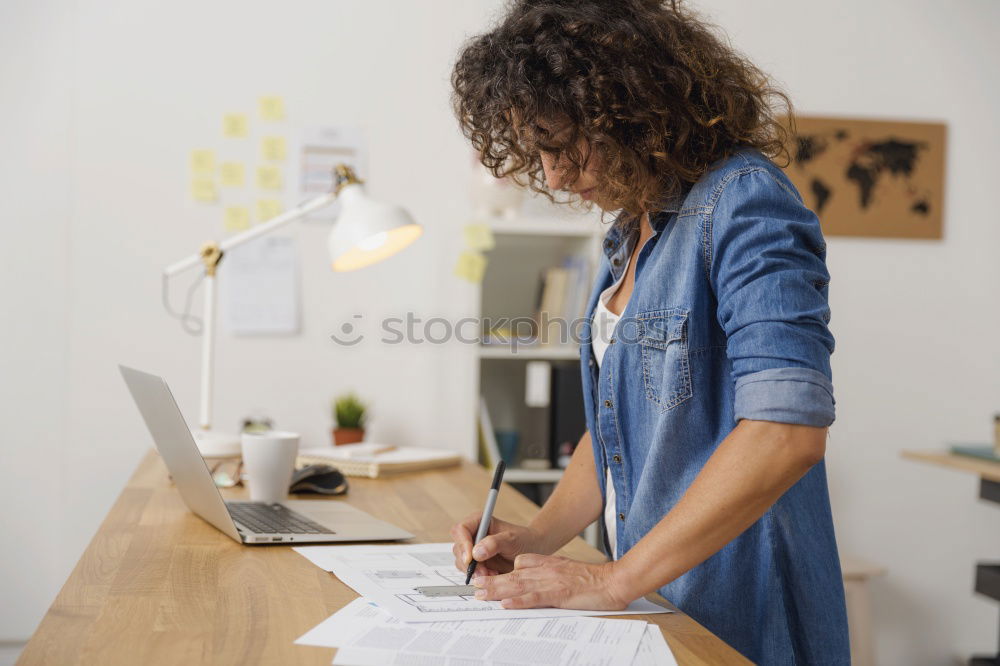 Similar – Young businesswoman working on laptop and drinking coffee