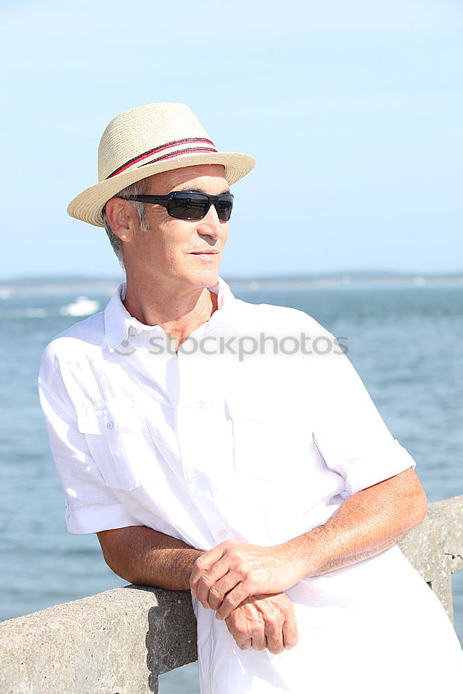 Happy fashionable senior man in tropical sunshine