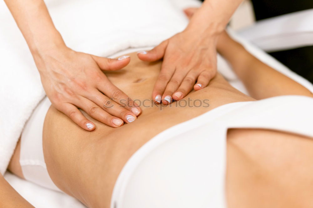 Similar – Top view of hands massaging female abdomen.