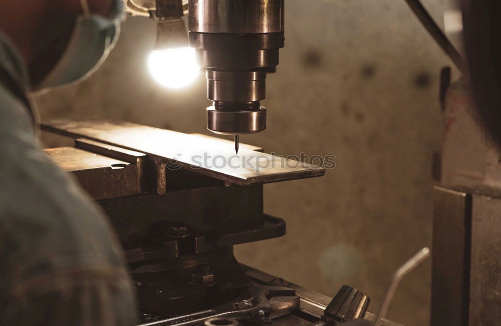 Similar – Unrecognizable worker cutting metal in garage