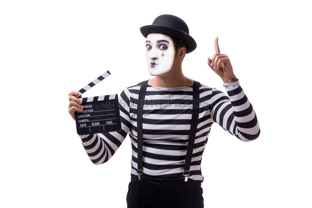 Similar – Young man with a clown costume is holding a little bike