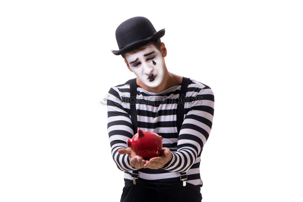 Similar – Young man with a clown costume is holding a little bike