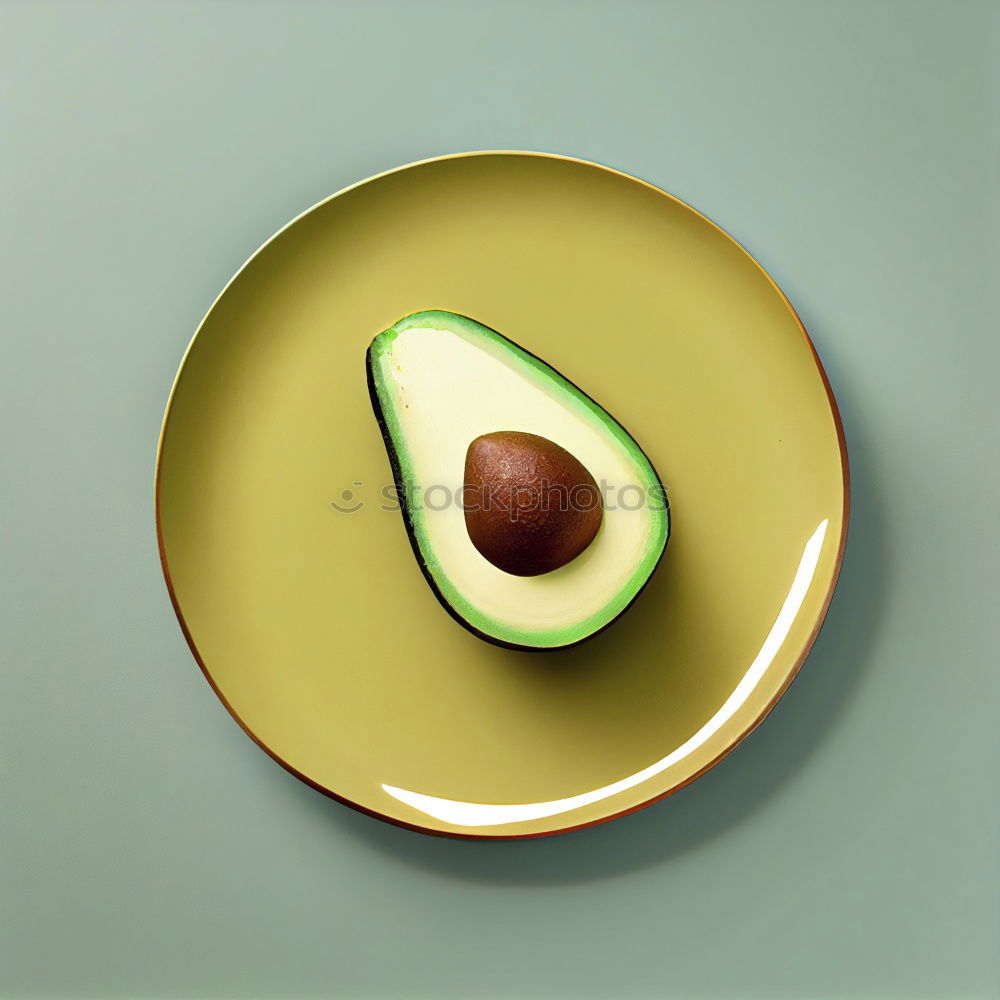 Similar – Cut avocado on white plate on pastel background