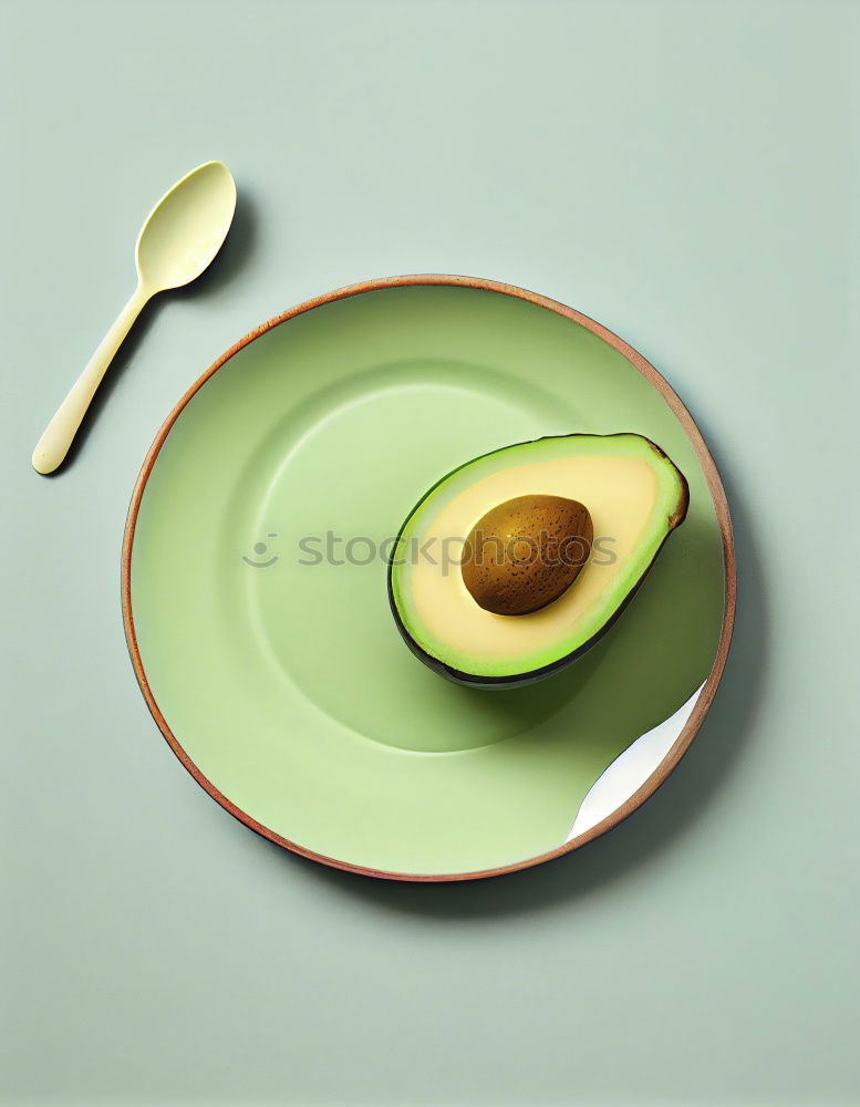 Similar – Cut avocado on white plate on pastel background